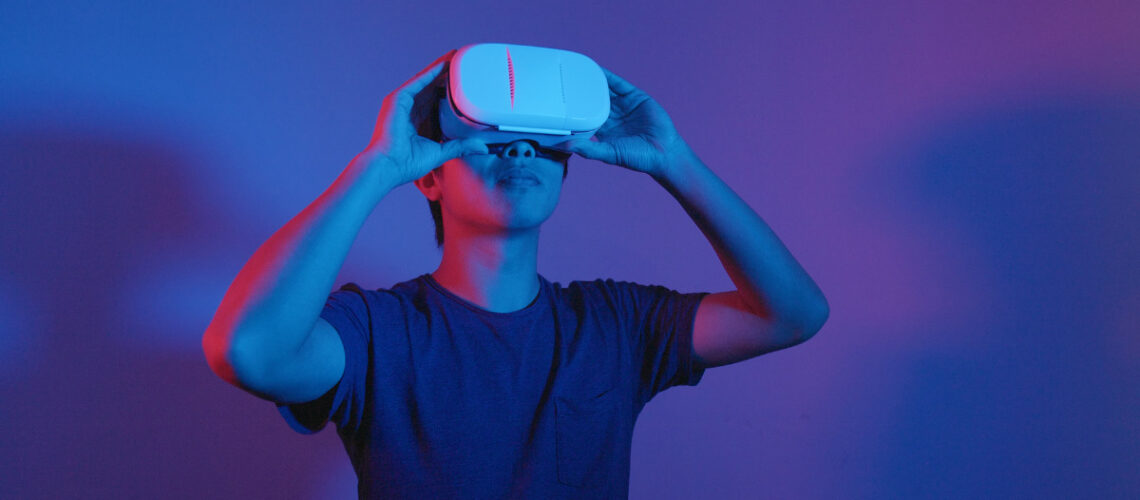 Young man using a Virtual Reality (VR) Headset.